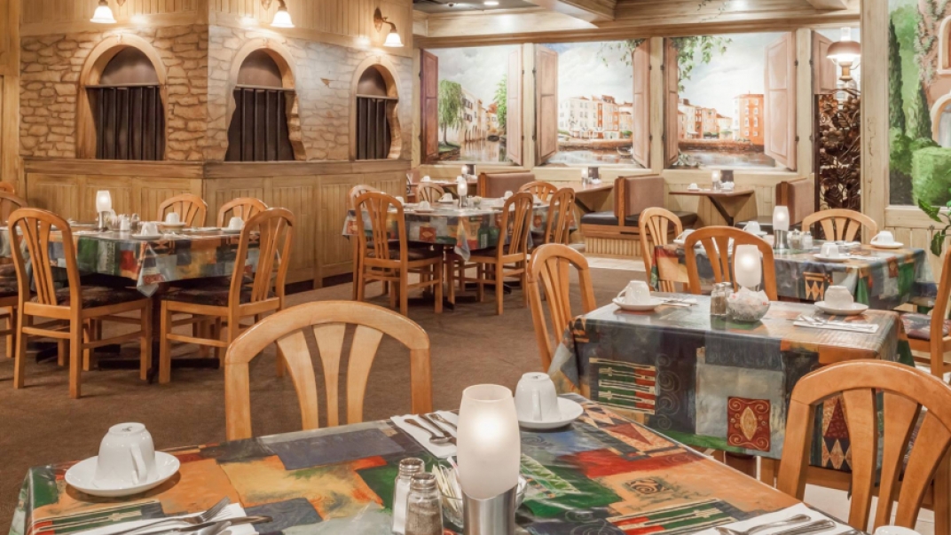 restaurant interior with wooden chairs and brick walls